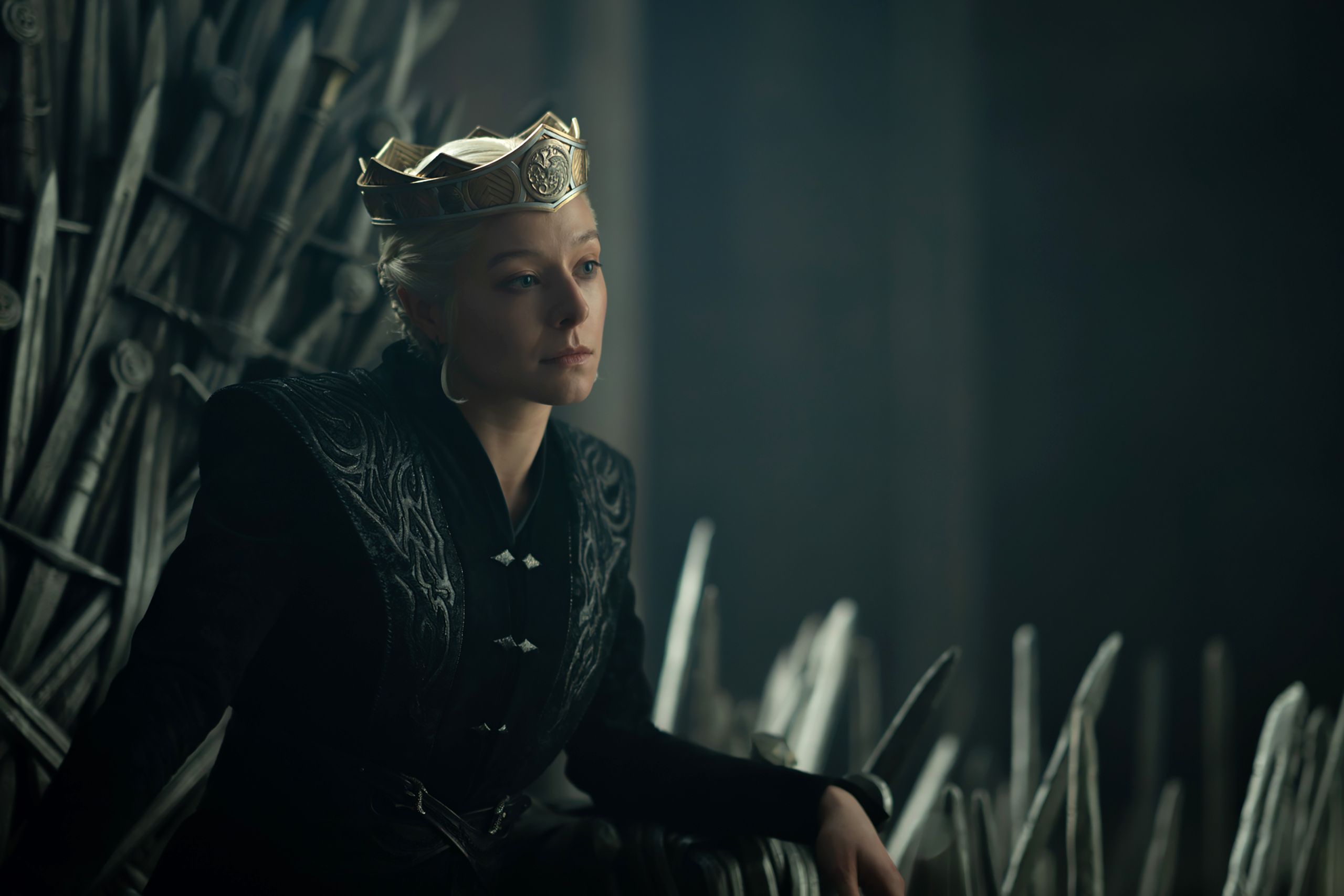 A figure sits on a throne made of swords.