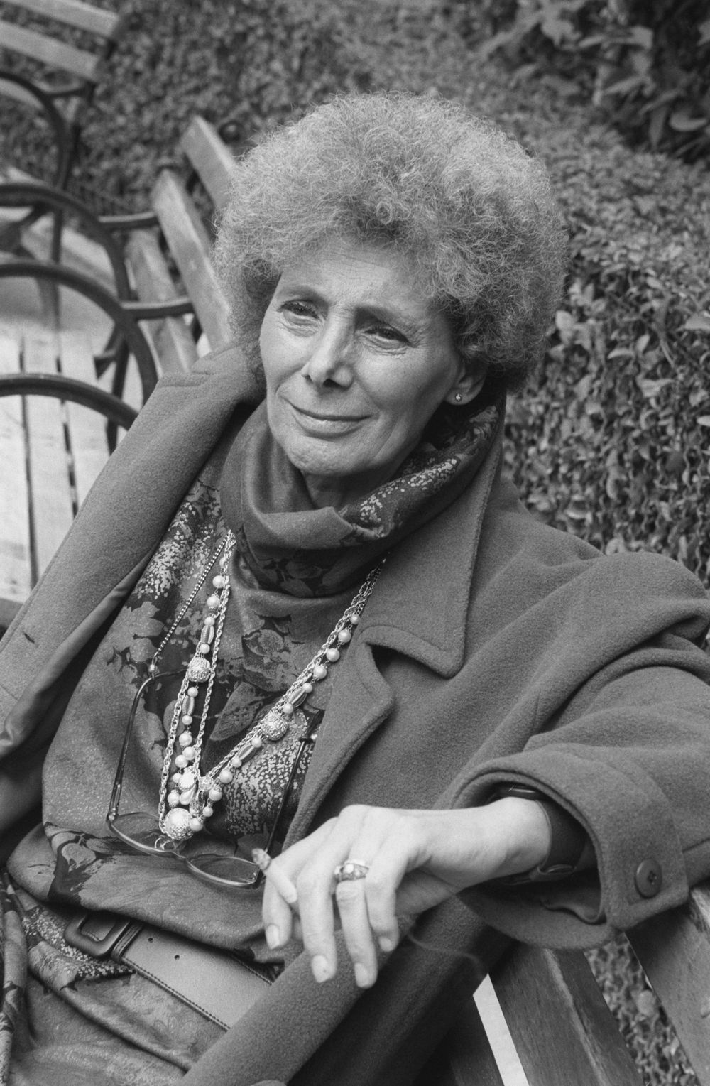 A portrait of a person on a bench. 