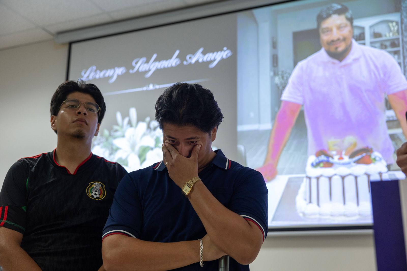 Man in tears standing in front of projector